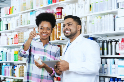 pharmacist and a customer smiling